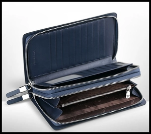 Detail of blue leather clutch showing dual zipper compartments and multi-card slot design