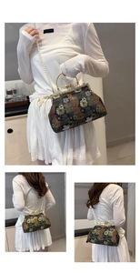 Detail of vintage floral embroidery purse with pearl chain strap and golden metal handle