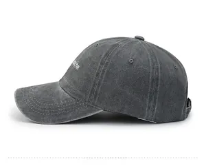 Side view of washed cotton baseball cap in charcoal grey with white embroidery