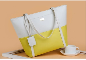 Detail of minimalist white and yellow patchwork tote bag with matching decorative tag