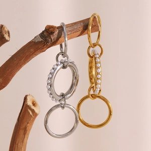Detail view of tiered 18K gold-plated rings and silver rings with inlaid pearls