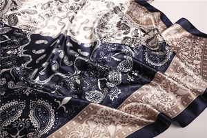 Detailed macro view of paisley pattern and smooth texture on two-tone satin silk scarf