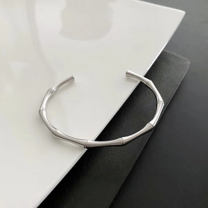 Detailed view of silver bamboo texture open bracelet with polished metallic finish