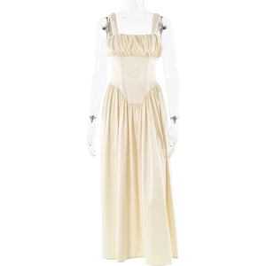 Detailed view of the pleated chest and spaghetti straps on a yellow maxi dress