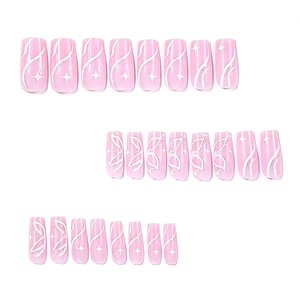 Long coffin press-on nails in pink with white wave lines, glitter, and star patterns