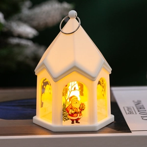 Close-up of white house-shaped Christmas lantern with Santa pattern and warm LED light