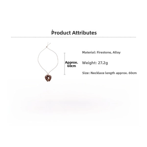 Detail shot of heart stone pendant with metal stars on long brown necklace cord