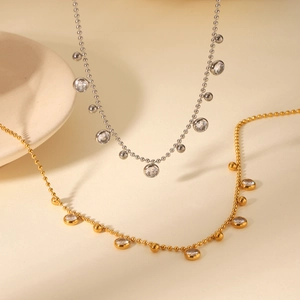 Detail of gold and silver beaded chains with sparkling zircon stones in a flat lay view