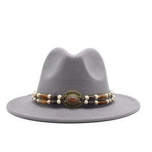 Detail of grey wool fedora hat featuring a bohemian beaded band and oval gemstone