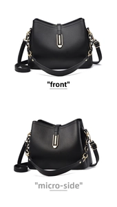 Detail view of black faux leather handbag with gold buckle and pebble grain texture