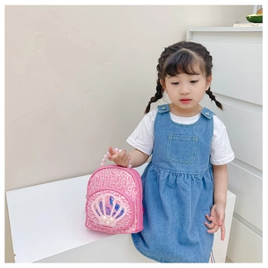 Detail of pink sequin kids backpack with shell decor and pearl bead handle