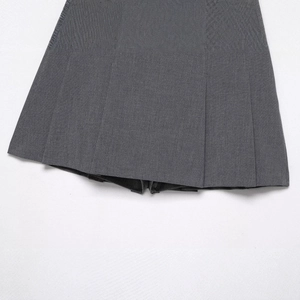 Dark grey pleated skort with belt featuring twill fabric texture and classic folding