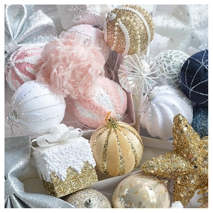 Detailed close-up of pink and gold Christmas ornaments with glitter and velvet texture