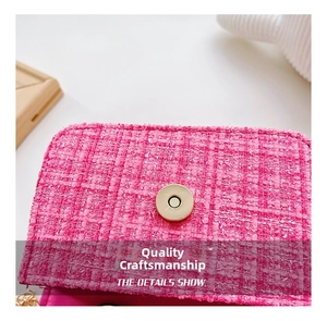 Detail of pink tweed girl's bag featuring a golden magnetic clasp and woven texture