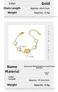 Detailed macro view of gold plated titanium steel bracelet with white shell flower charms
