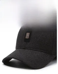 Close-up of the GOLF SPORT metal logo and textured herringbone fabric on the winter cap