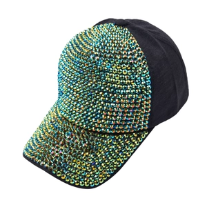 Detailed view of black baseball cap with vibrant green and gold rhinestones on front