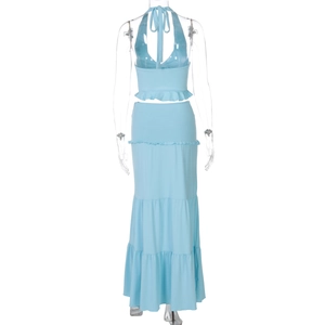 Detail of light blue two-piece set featuring backless halter top and tiered maxi skirt