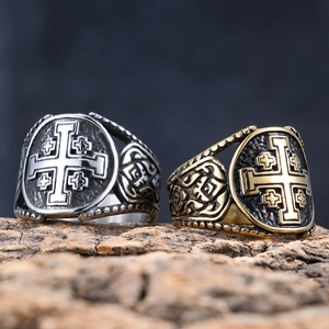 Vintage Lorraine cross rings in silver and gold steel finish on a rustic wood base