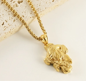 Detailed view of golden Desert Eagle pendant with embossed texture on stone surface