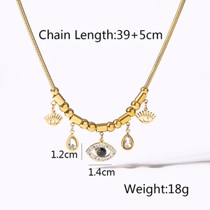 Detail view of gold snake chain necklace with evil eye pendants and dimensions