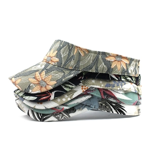 Multiple ethnic print sun visors showing diverse floral patterns in a stacked layout