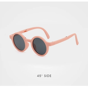 Detail view showing a 45-degree angle of pink foldable round frame kids sunglasses