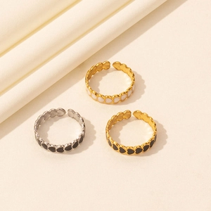 Three minimalist heart-shaped drip oil open rings in gold and silver finishes on fabric
