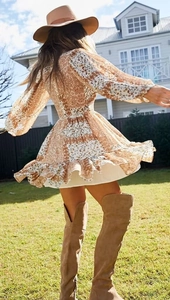 Dynamic flow of Bohemian patchwork floral mini dress with long sleeves and wavy hemline