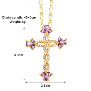 Detail view of gold cross pendant with purple pear-cut gem and size measurements