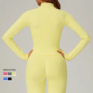 Slim fit yellow yoga jacket and high waist leggings set with thumb holes on model's back