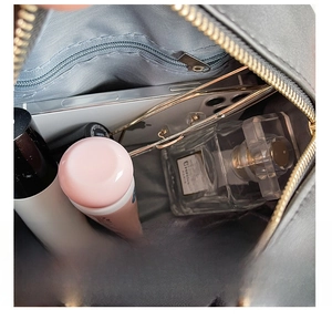 Detail view of the spacious inner compartment with zipper pocket and daily essentials