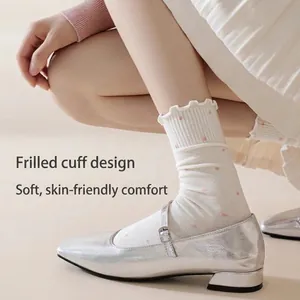 Sweet cream cotton crew socks with pink polka dots and ruffled cuffs for women