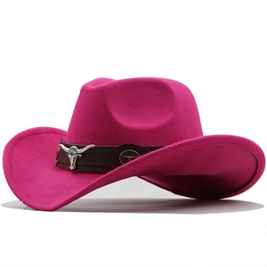 Detail of western cowboy hat with brown leather band and silver bull head emblem