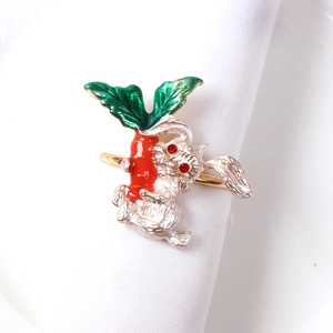 Gold napkin ring featuring a silver metal rabbit holding an orange enamel carrot detail