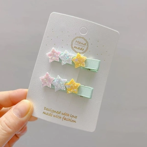 Sparkly star hair clips for girls with glitter stars and green ribbed fabric base