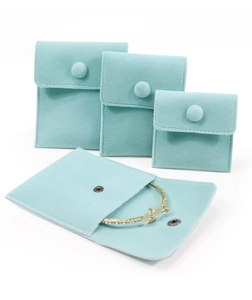 Detailed view of mint green velvet jewelry pouches in multiple sizes with button closure