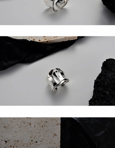 Detailed macro view of silver open ring with textured origami fold and lava surface