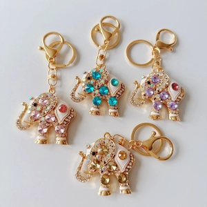 Detail of cute alloy elephant keychains with colorful rhinestones in pink, blue, and purple