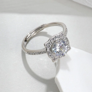 Macro shot of silver ring with red corundum and brilliant round-cut zircon crystals