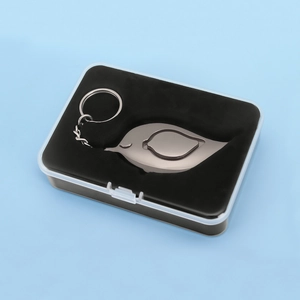Bird-shaped metal personal safety alarm in a transparent gift box with black lining