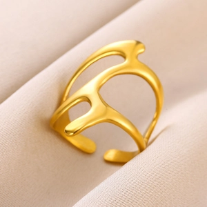 Close-up of gold stainless steel open ring with fluid hollow design on silk background