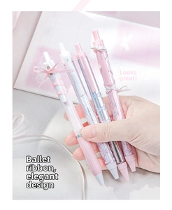 Close-up of four aesthetic coquette ballet ribbon style retractable gel pens in soft colors