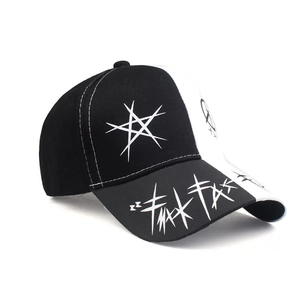Detail of black and white two-tone baseball cap with star embroidery and graffiti brim