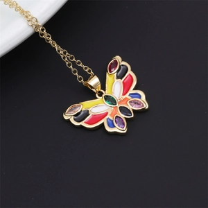 Close-up of a colorful butterfly pendant featuring vibrant gems on a delicate gold chain