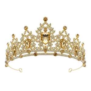 Close-up of golden Baroque crown with champagne crystals and intricate rhinestone details