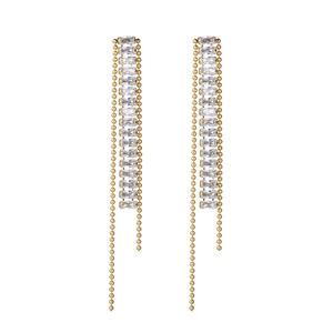 Detail of gold tassel earrings featuring baguette-cut crystals and elegant ball chains