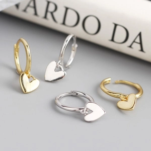 Elegant gold and silver heart hoop earrings set with a minimalist polished metal finish