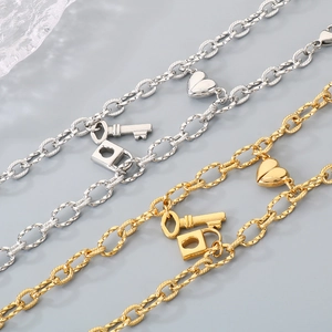 Magnetic heart couple bracelets with key and lock charms in gold and silver finish