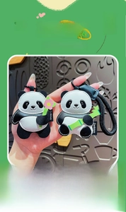 Detail of premium leather panda keychains featuring floral and bamboo motifs with stitching